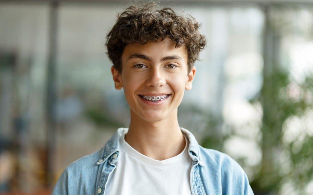 teenager smiling with braces from senan orthodontic studios