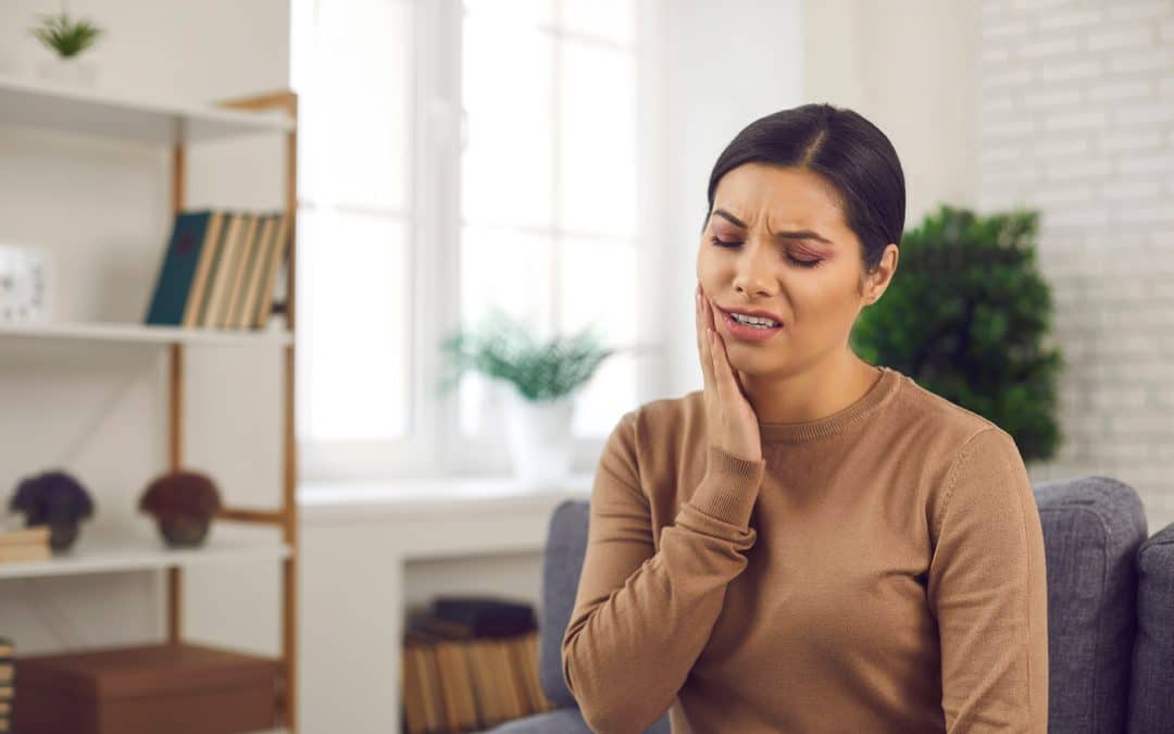 woman holding jaw with tmj pain in mcallen texas